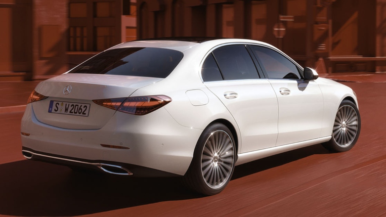 Vista trasera de auto de lujo Mercedes-Benz Clase C blanco en calles de ciudad.